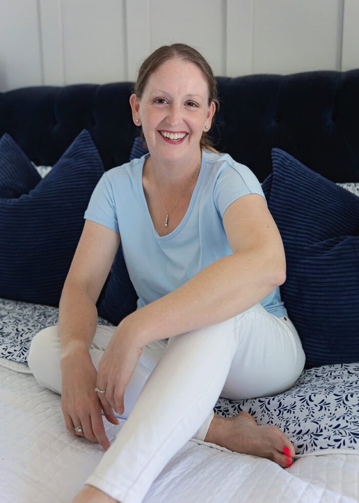 Megan sitting on blue bed