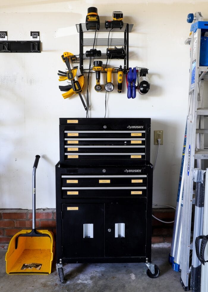 Husky rolling toolbox with power tool storage organizer hung on the wall above