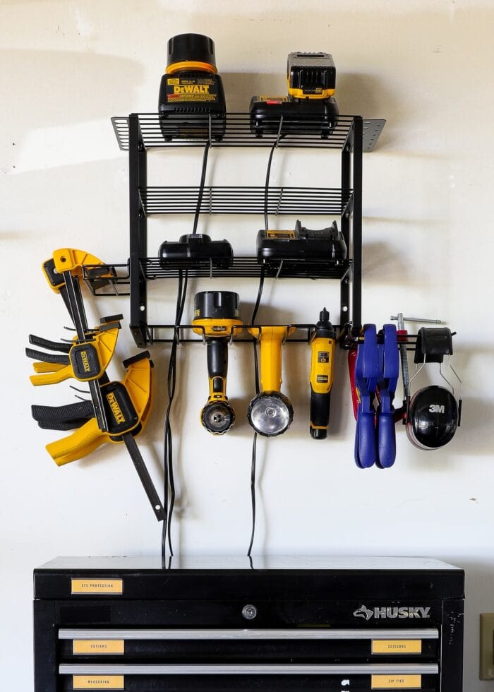 Power tool storage organizer hung on the wall in a garage