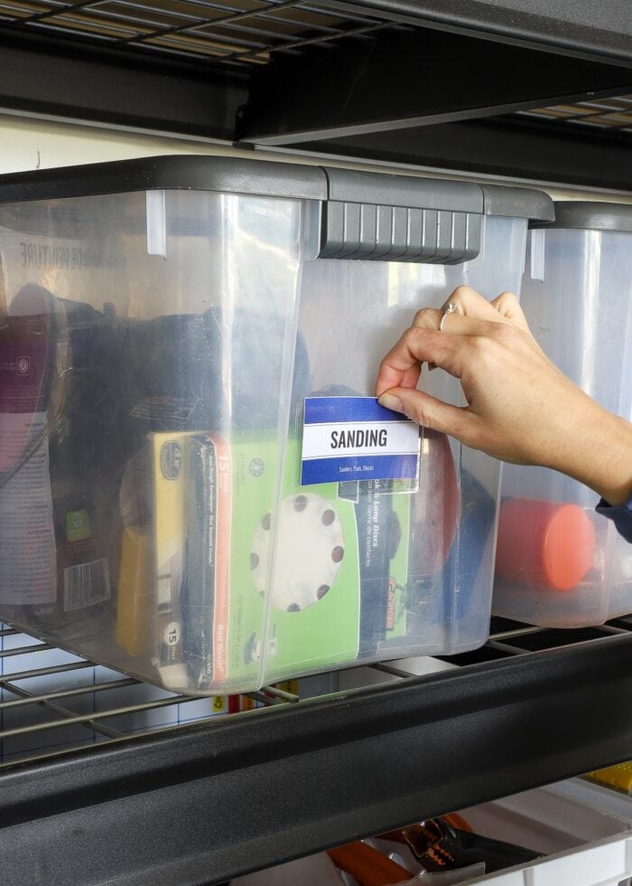 Handing placing a "Sanding" label on a garage bin