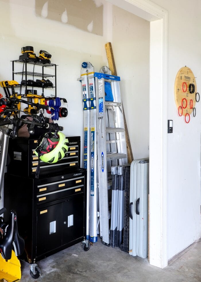 Ladders and work benches stored in the corner of a garage nook