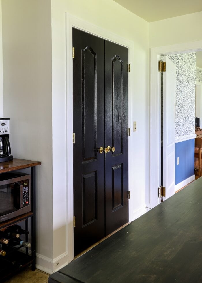 Black pantry doors in this rental kitchen makeover