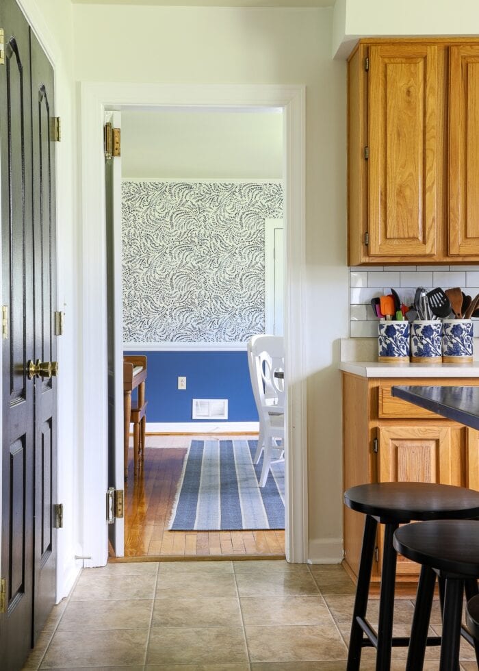 Blue and white dining room shown just beyond oak rental kitchen