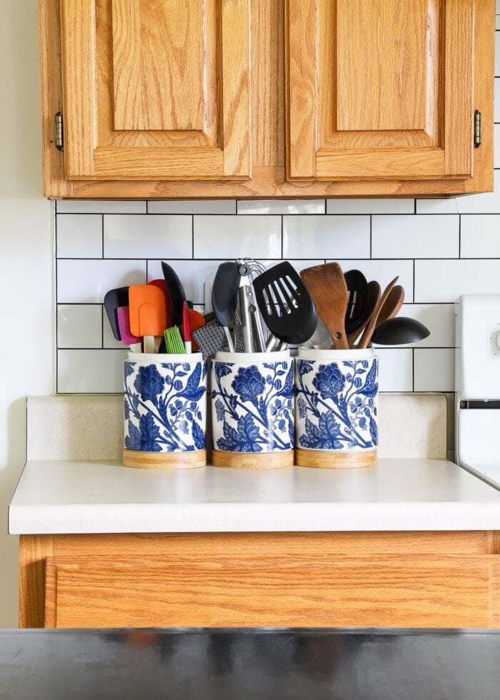 Blue and white flower utensil caddies on the kitchen counter