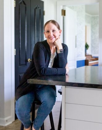 Megan from The Homes I Have Made sitting at a rental kitchen island