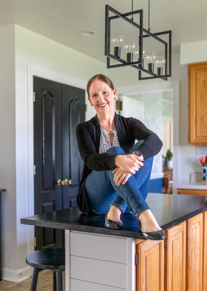 Megan from The Homes I Have Made sitting on a rental kitchen island