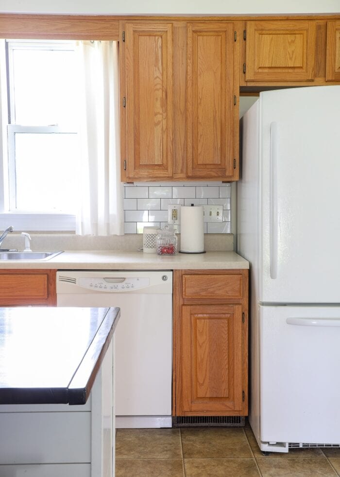 While peel and stick subway tile on the backsplash of a rental kitchen