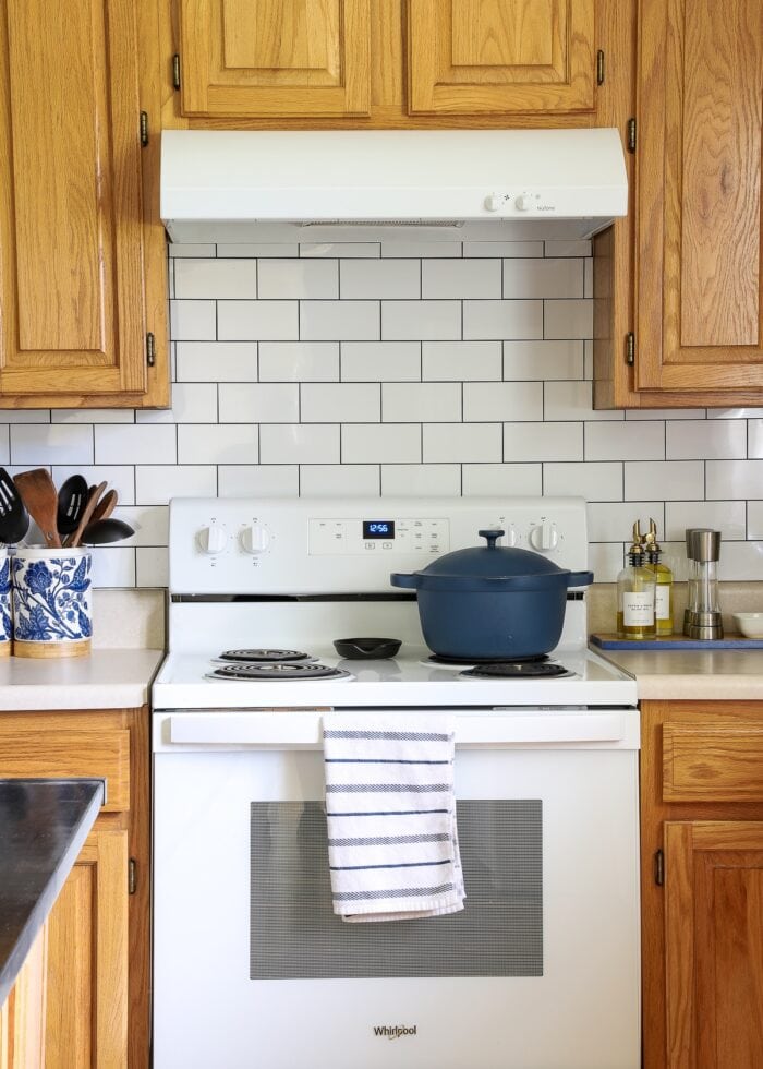 While peel and stick subway tile on the backsplash of a rental kitchen