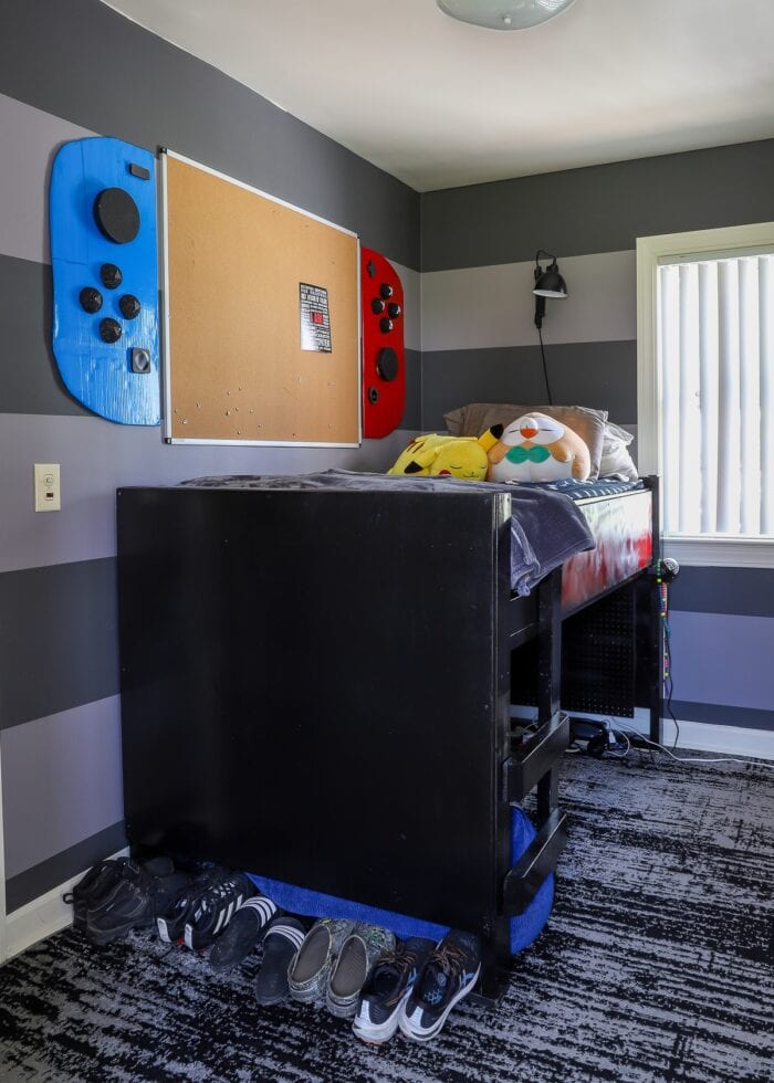 Small teen bedroom with loft bed and Nintendo Switch bulletin board on wall