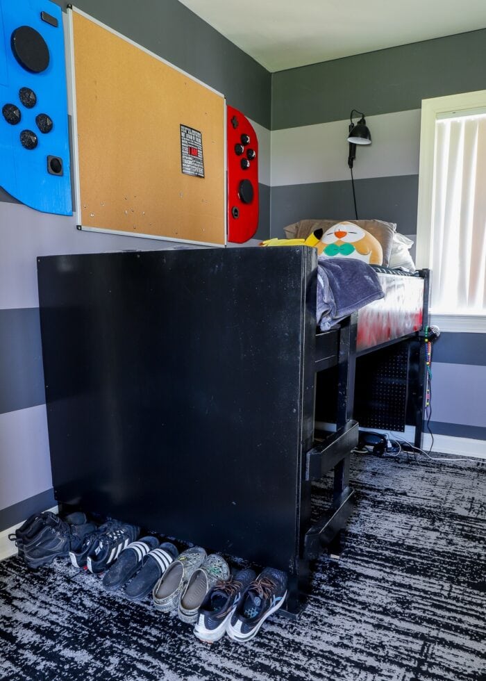 Small teen bedroom with loft bed and Nintendo Switch bulletin board on wall