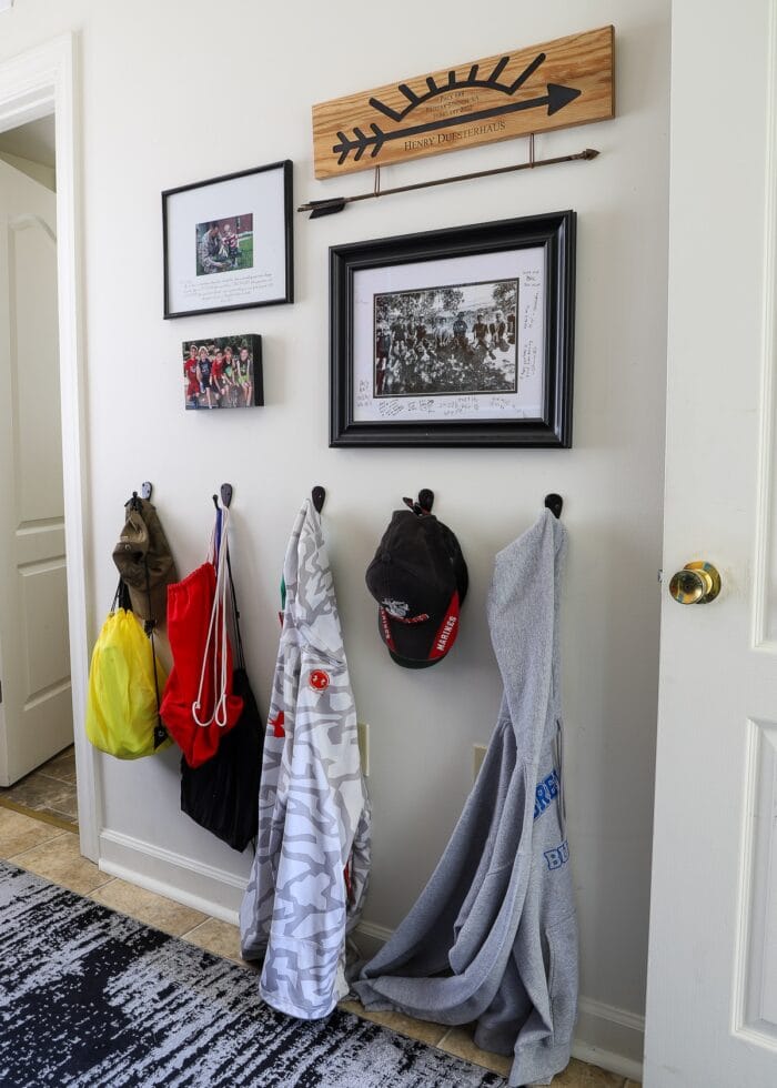 Hooks and artwork on the wall in a small teen bedroom