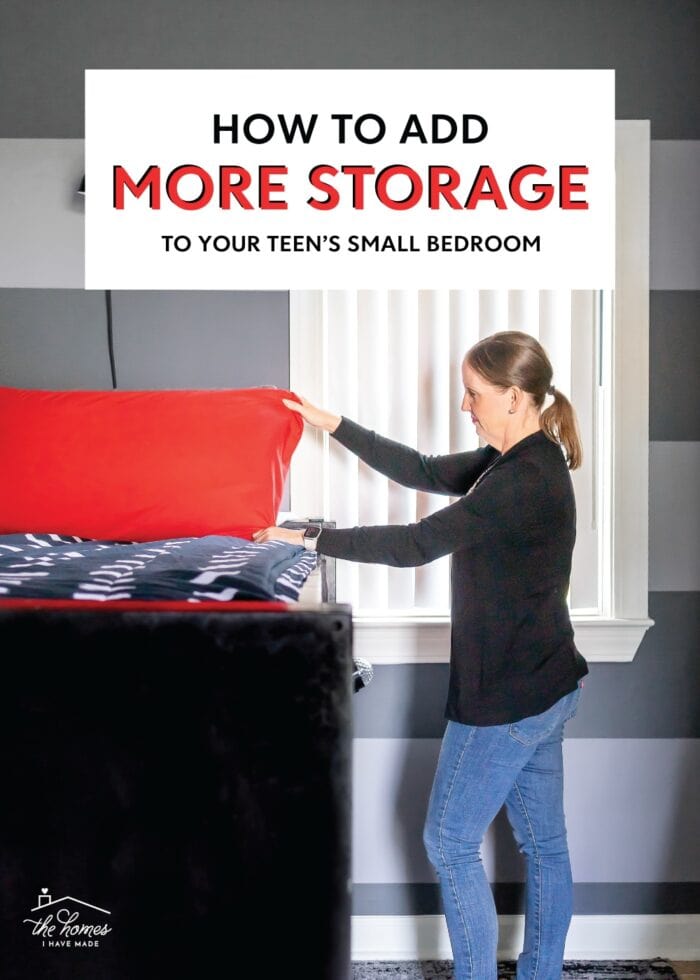 Megan fluffing a red pillow in a small grey, black, and red teen bedroom