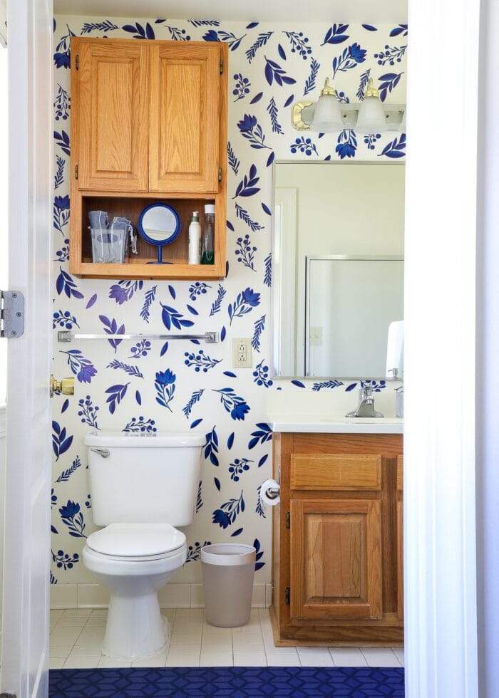 Master bathroom with oak bathroom cabinets and blue flowered wall decals