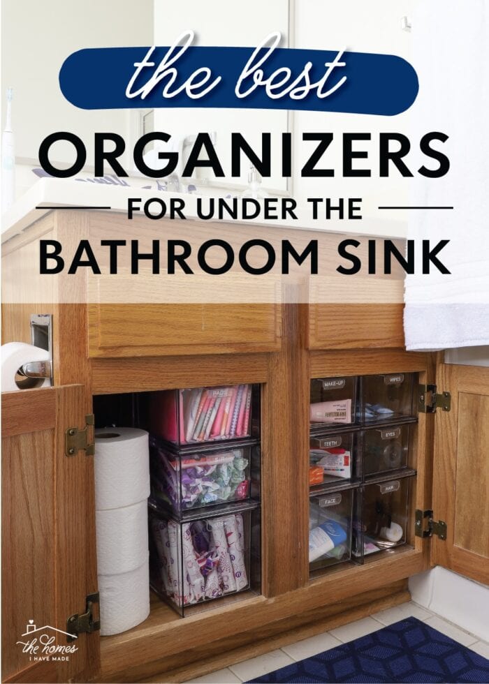 Oak cabinet under the bathroom sink organized with clear acrylic drawers to hold toiletries