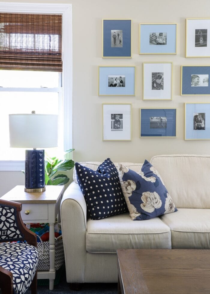 White couch with blue pillows and blue lamp in a family room