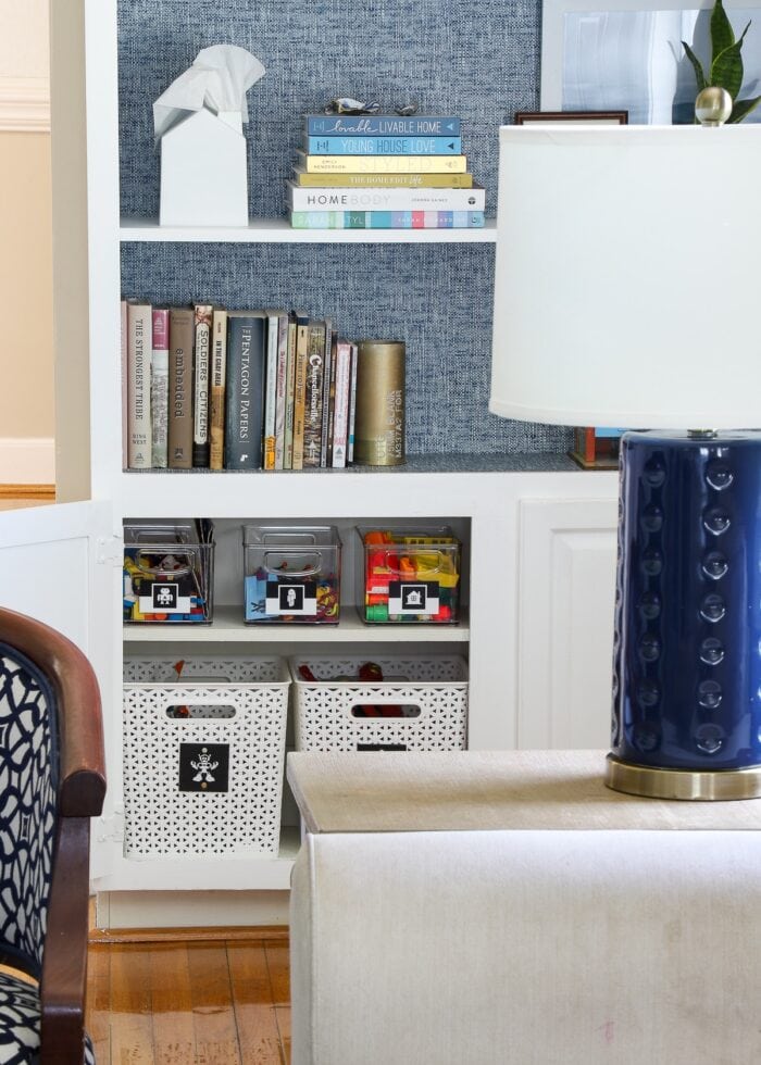 Built-in cabinets with doors open to expose baskets of toys