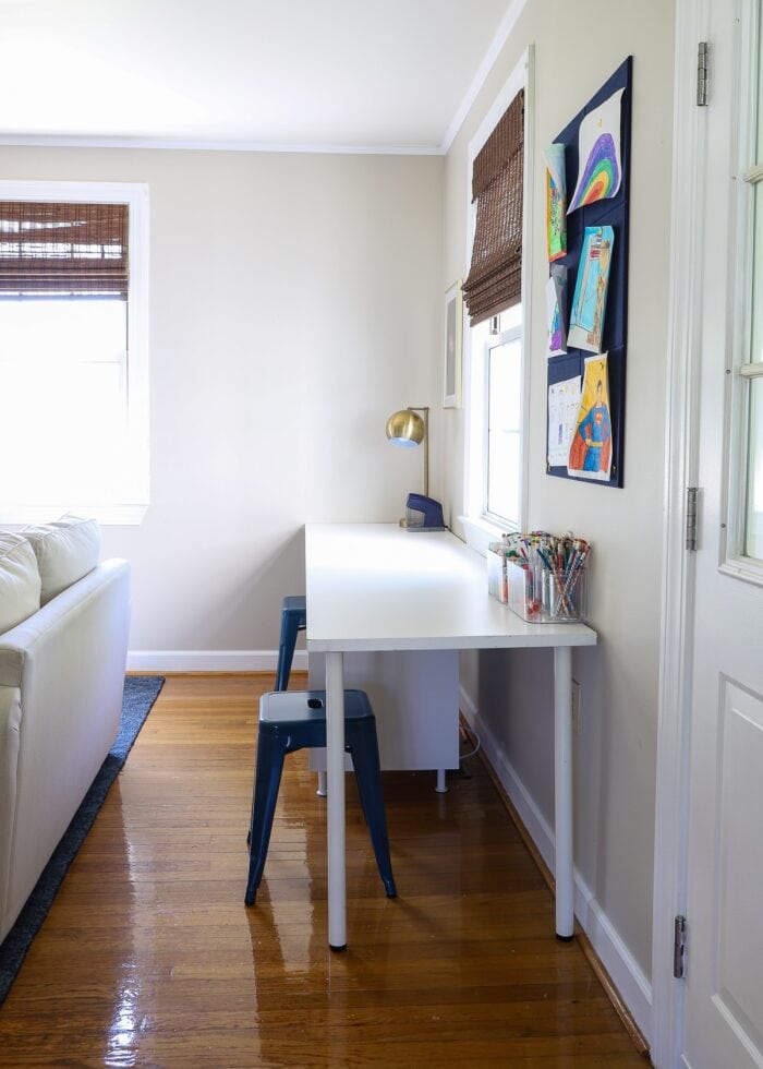 Kids' art table tucked into the corner of a living room