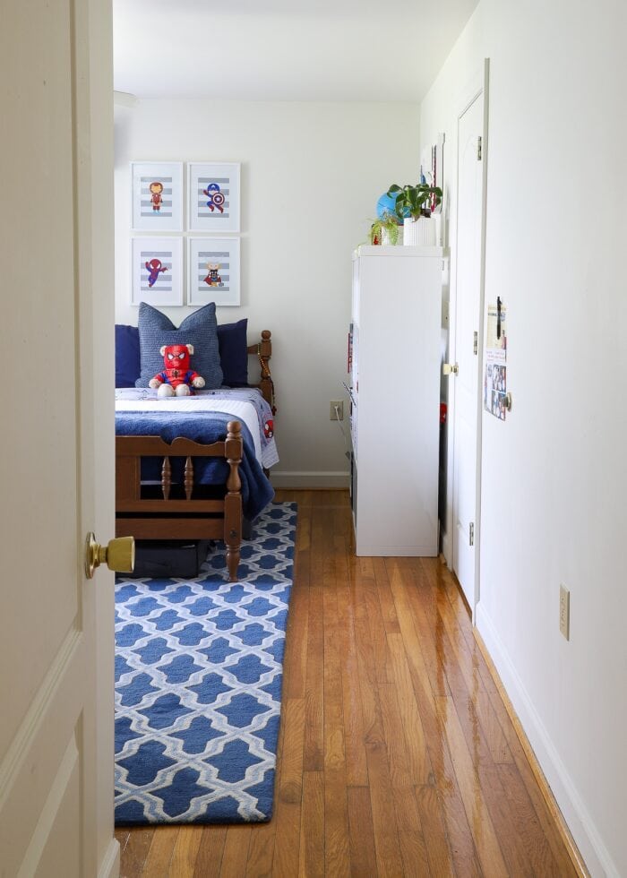 Short hallway leading into a large shared boys' bedroom