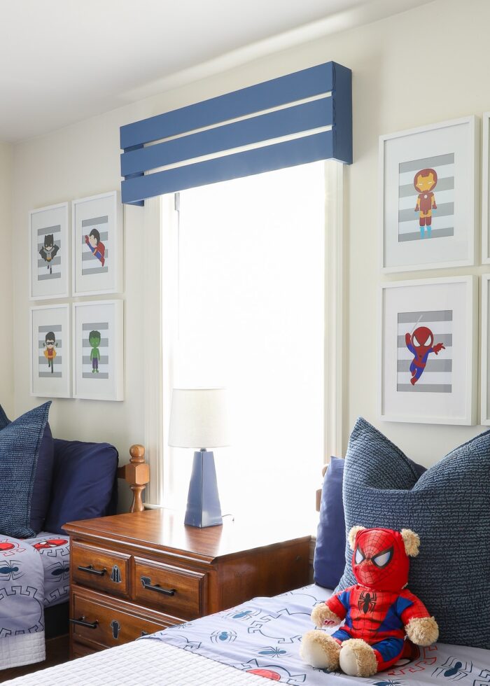 Side shot of the blue wooden valances hung in this boys' shared bedroom.