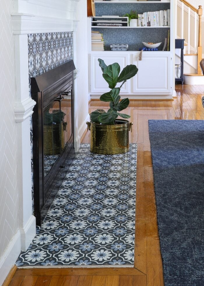A rental fireplace with Floor Pops! titles installed on the hearth