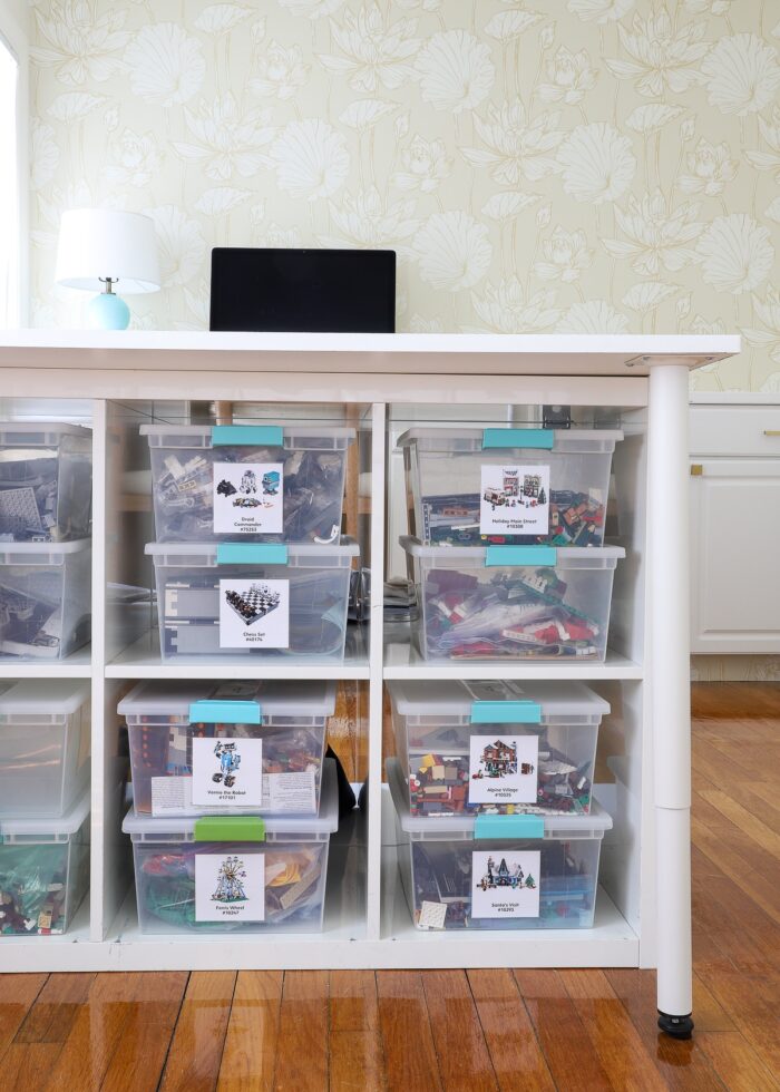 IKEA Kallax units holding LEGO sets underneath a large work table