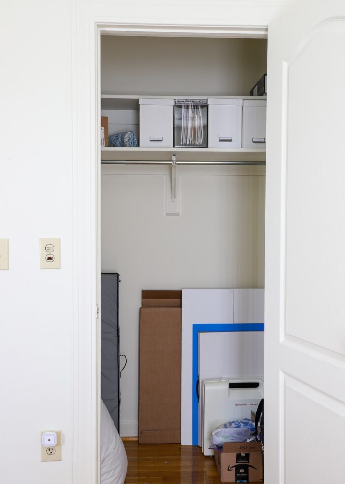 A mostly-empty closet filled with files and leftover craft supplies