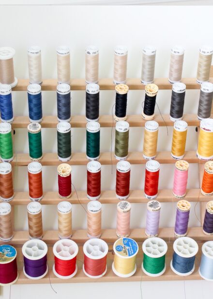 Sewing thread on a spool holder organized by color