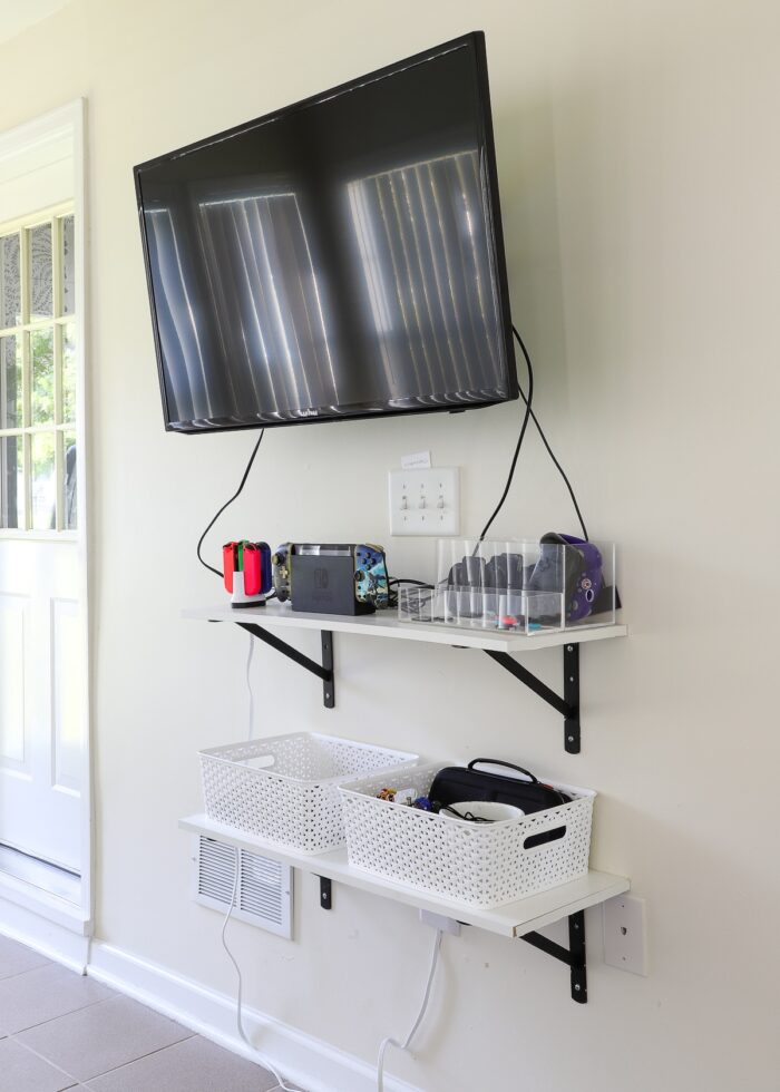 TV and gaming devices mounted on a wall in an exercise room