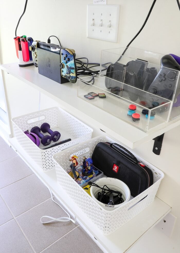 Wall-mounted shelves with gaming accessories inside baskets