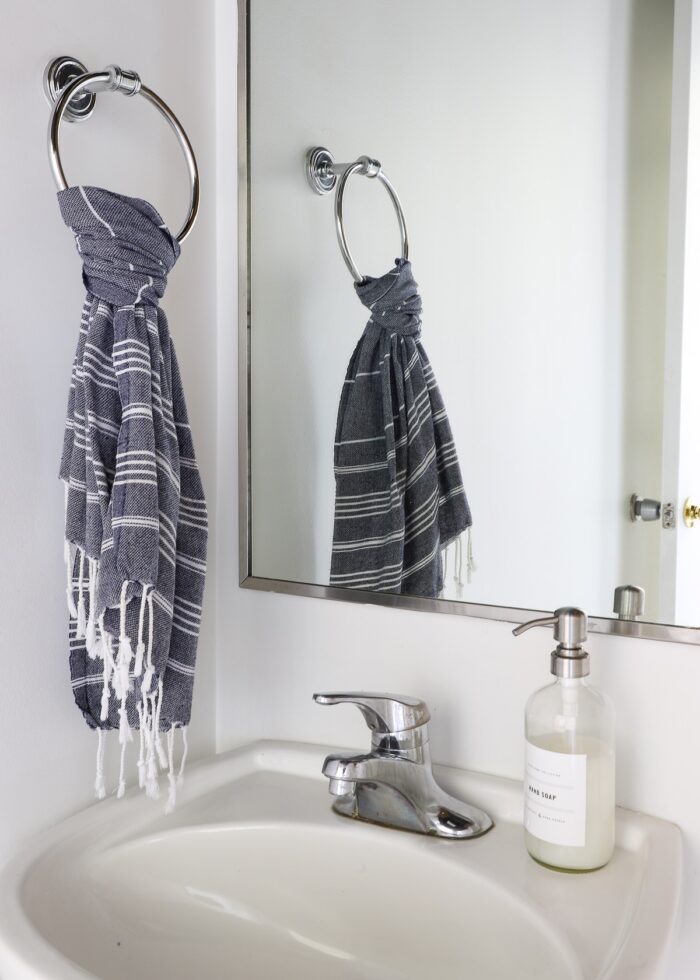 Turkish hand towel and soap dispenser on pedestal sink