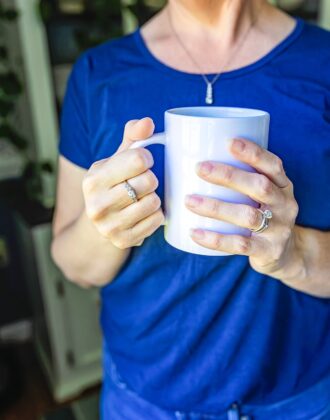 Megan in blue shirt with white coffee mug