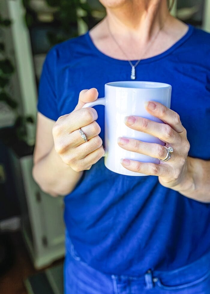 Megan in blue shirt with white coffee mug