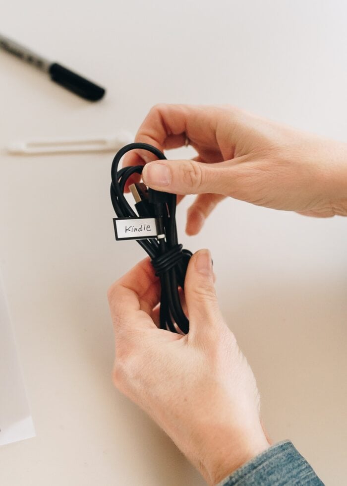 Megan holding a tidy, labeled charging cord
