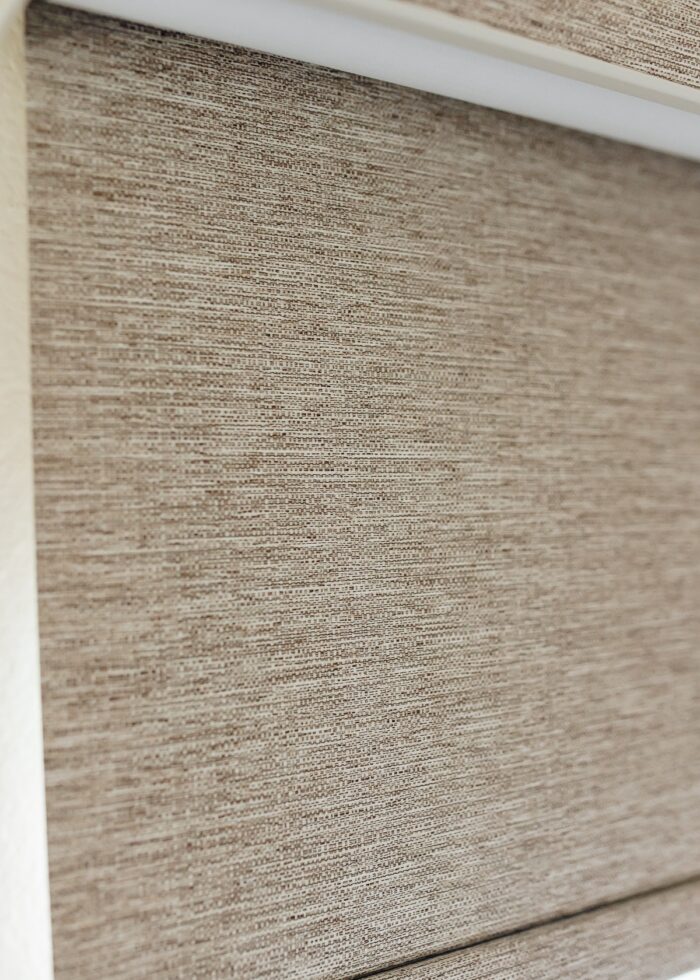 Close up detail of a brown textured roller shade