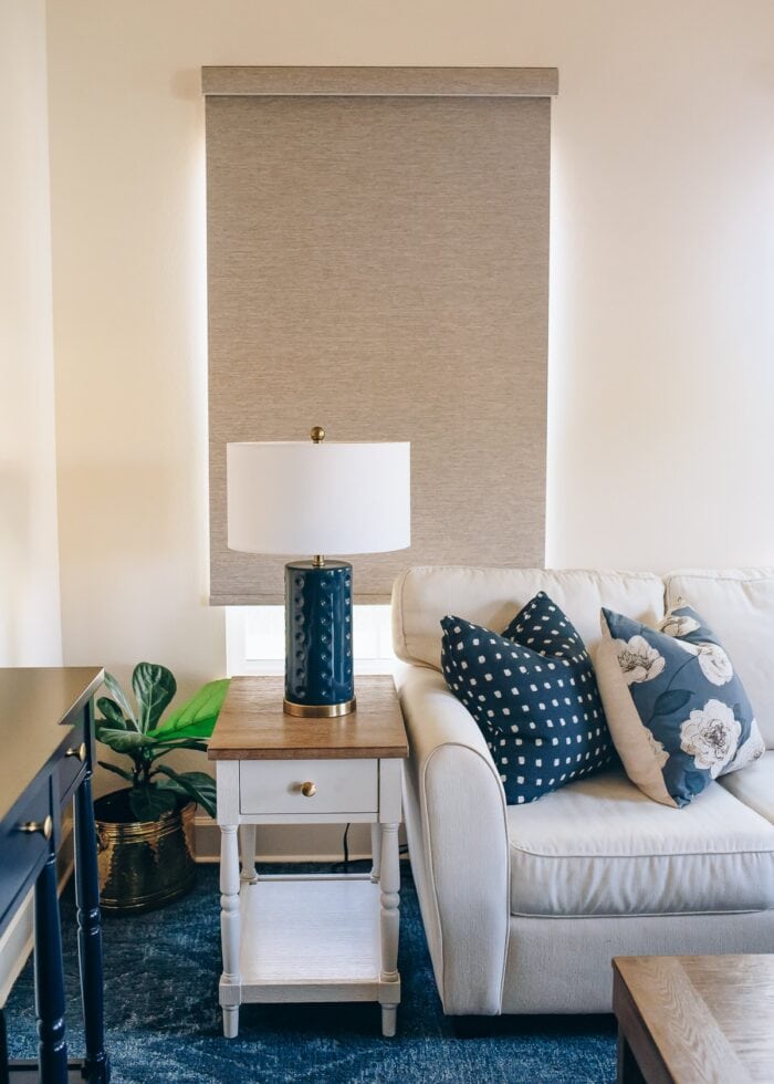 Brown textured blackout roller shade pulled down over a window