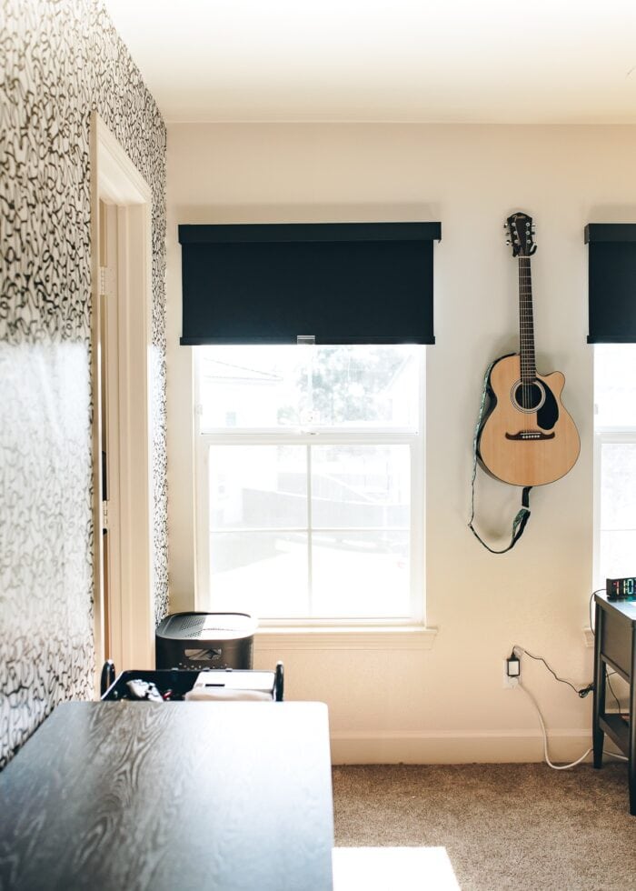 Black fabric blackout roller shade on a teen bedroom window