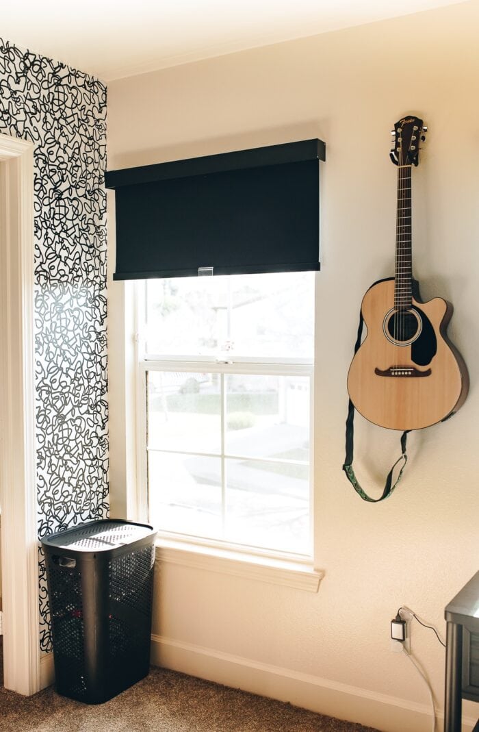 Black fabric blackout roller shade on a teen bedroom window