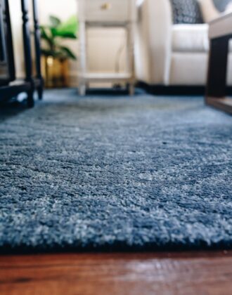 A close-up shot of a blue wool rug