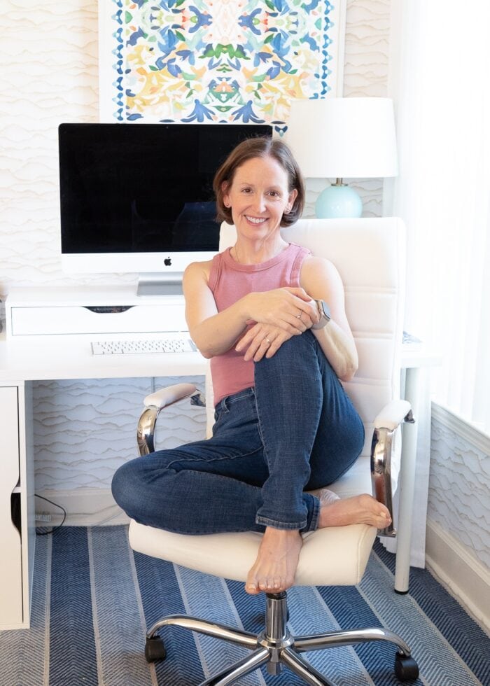 Megan sitting in white office chair in front of a computer