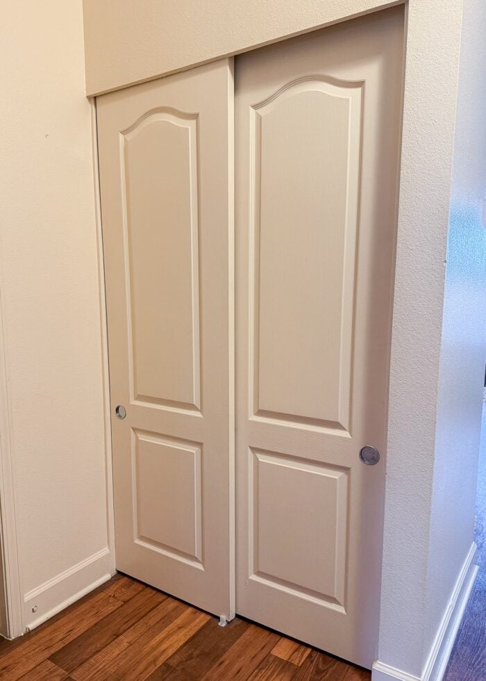 A foyer closet with two sliding doors