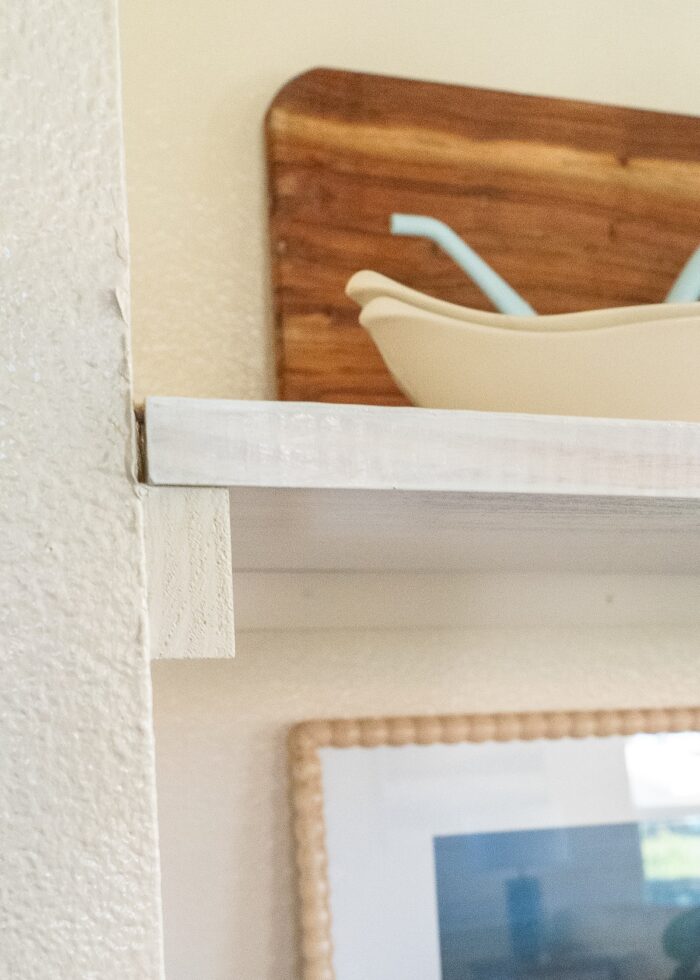 Close up shot of the return ledges and shelf boards that make up the floating shelves inside a wall nook