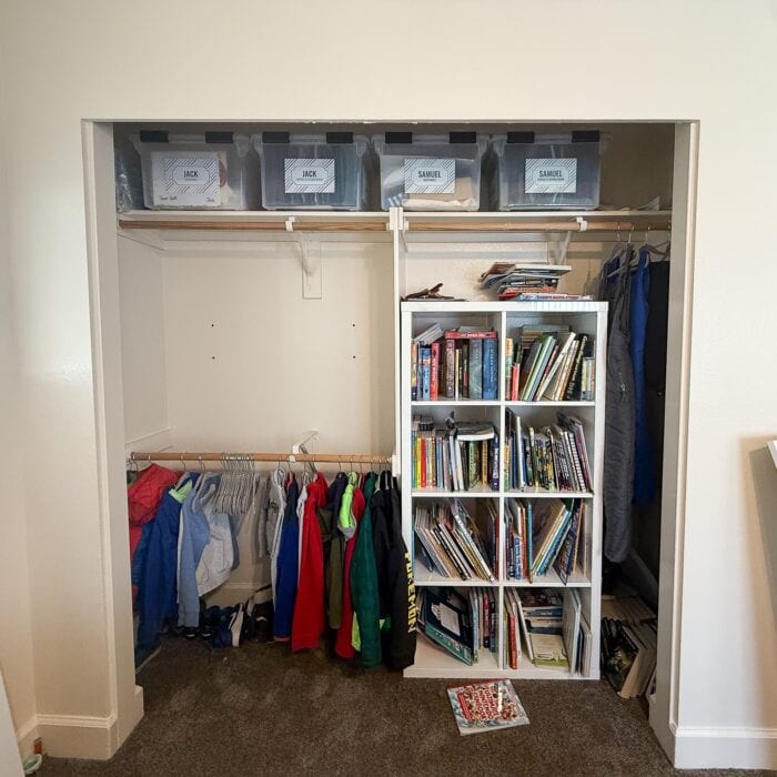 A double-wide closet with double hanging rod and an IKEA Kallax on one side