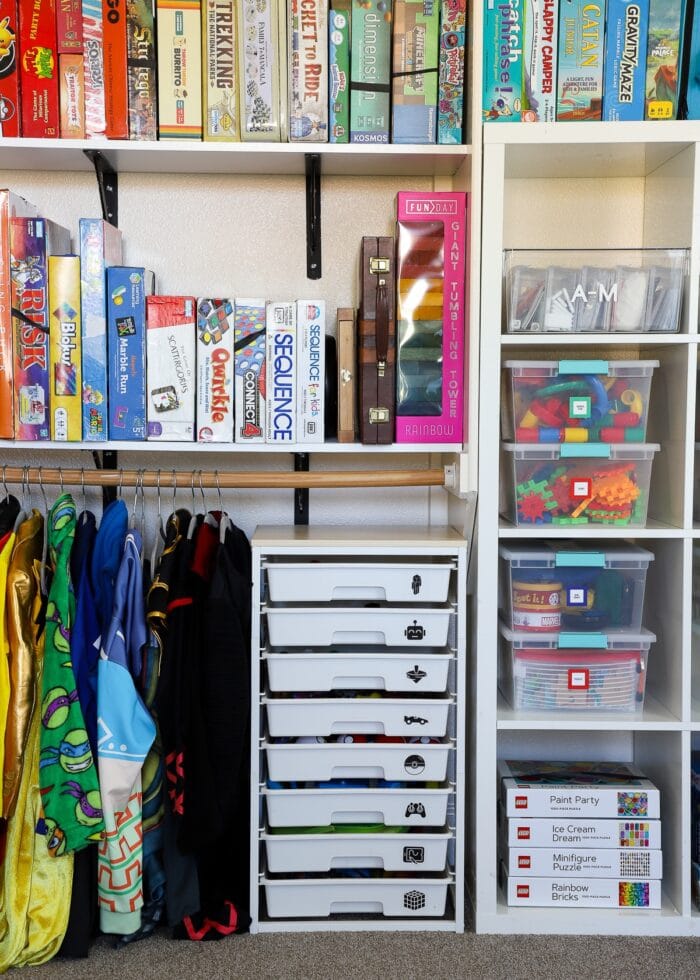 An organized playroom closet with games, toys, costumes and more.