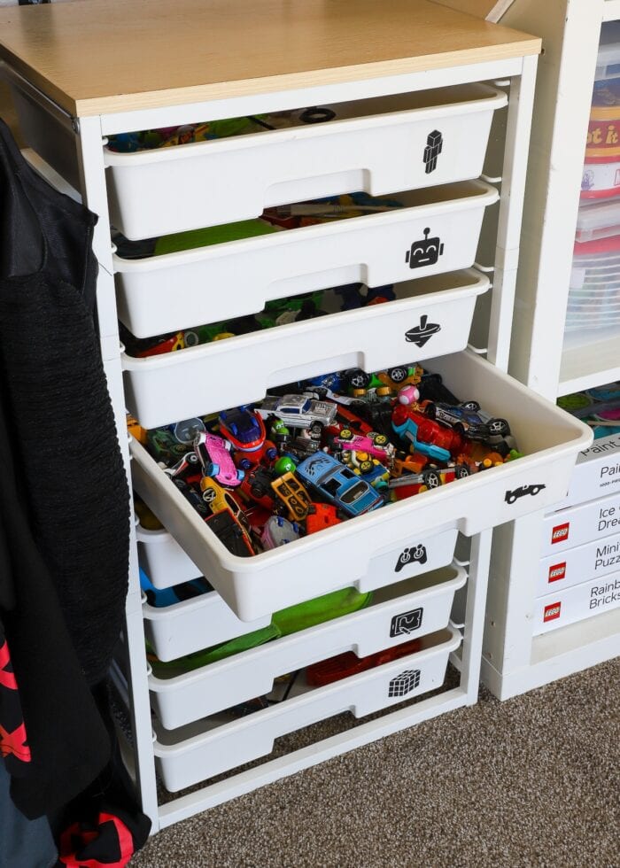 A drawer caddy in a playroom closet holds lots of small race cars