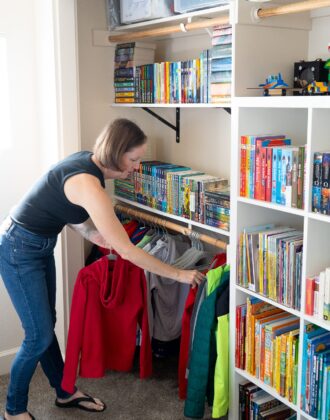 Megan organizing jackets in an organized bedroom closet