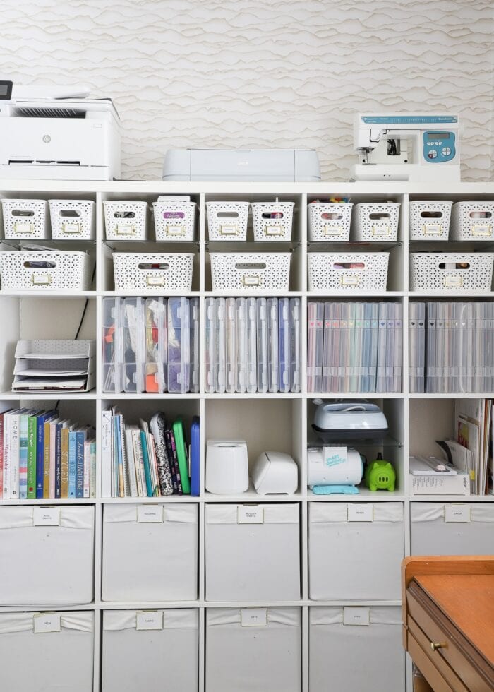 A 5x5 IKEA Kallax shelf filled with various bins, baskets, and cases holding a wide variety of craft supplies