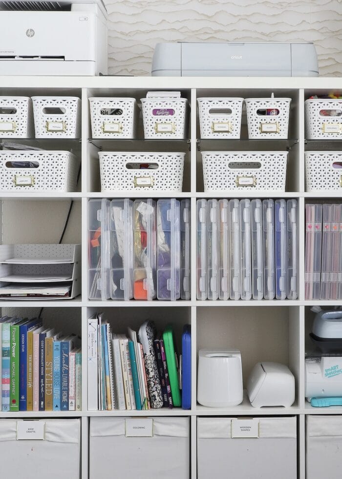 A 5x5 IKEA Kallax shelf filled with various bins, baskets, and cases holding a wide variety of craft supplies