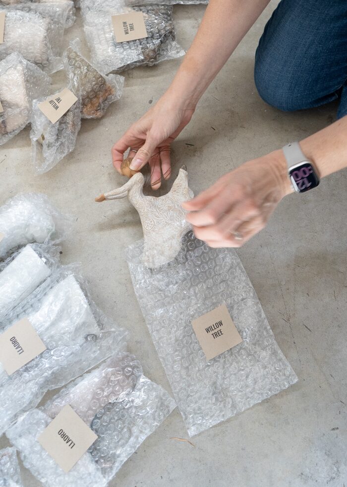Megan putting a Willow Tree angel in a plastic bubble wrap pouch
