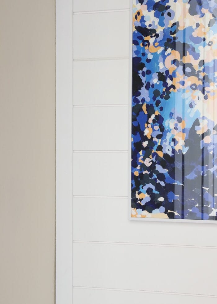 Trim on the side of white shiplap wall paneling