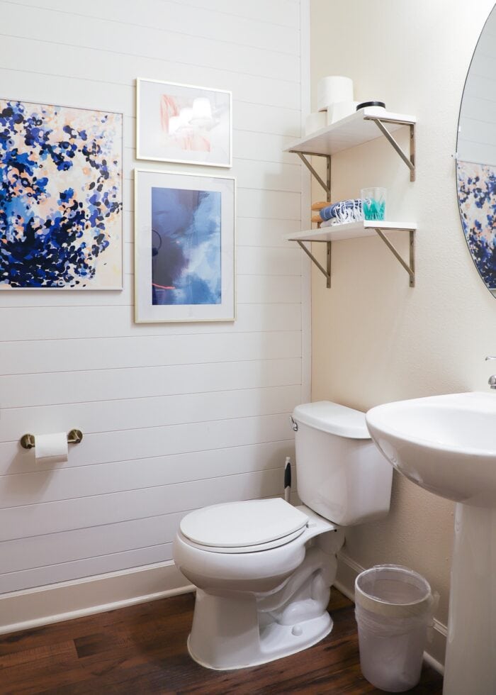 A rental bathroom upgraded and decorated with white shiplap wall paneling